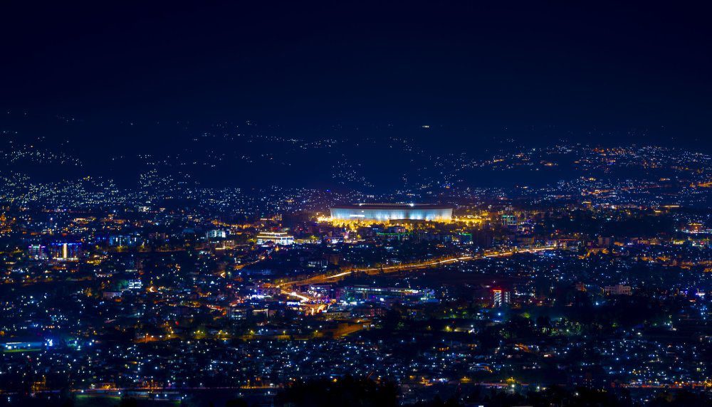 Kigali city skyline at night, brightly lit with modern architecture and roads, showcasing a vibrant destination for top annual events and cultural highlights—perfect for travelers exploring things to do in Rwanda.